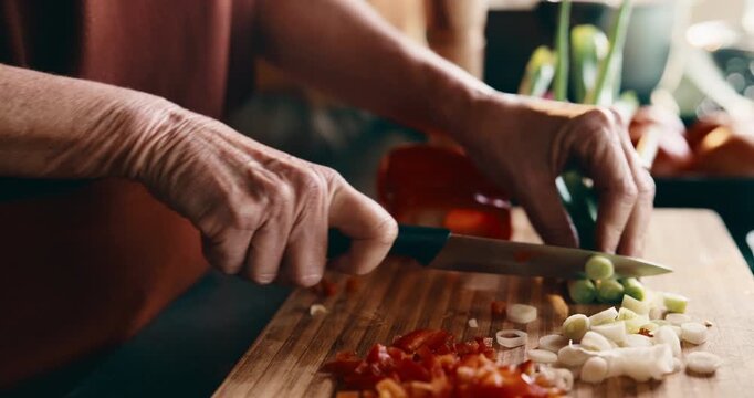 Hands, vegetables and woman in kitchen at house for nutrition, health and cooking meal for diet. Knife, spring onion and female person cutting ingredients for dinner, food or supper in apartment.