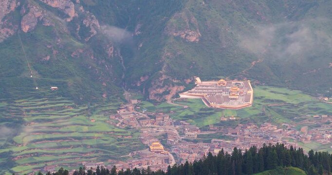 Panoramic view of Zhagana village in morning mist, Gannan Gansu, natural scenery of mountain valley with Tibetan settlements	
