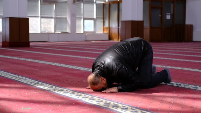 Man Prostrating his Forehead to Pray in the Masjid