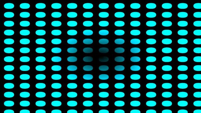 Abstract pattern of glowing blue oval lights on a black background with a blurred center.