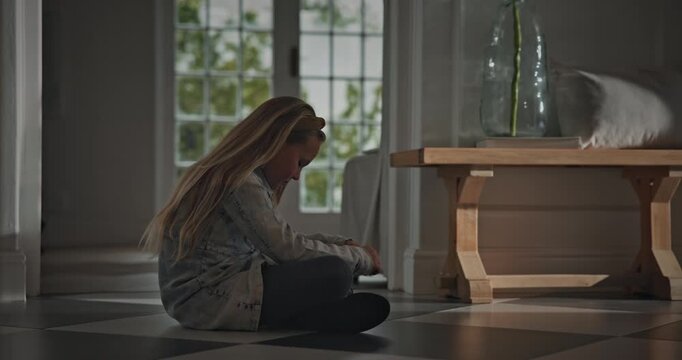 Sad, child and thinking on floor in home for emotional neglect, abandoned or self isolation. Mental health, overthinking or girl with depression in house for loneliness, trauma anxiety or overwhelmed