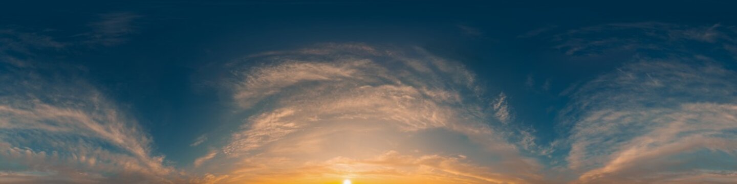 Panorama sunset sky with golden light and wispy clouds in a clear 360 degree equirectangular view with copy space
