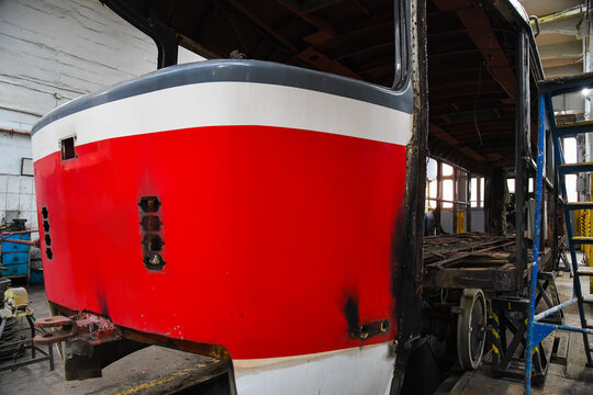 Vintage tram undergoing workshop restoration.