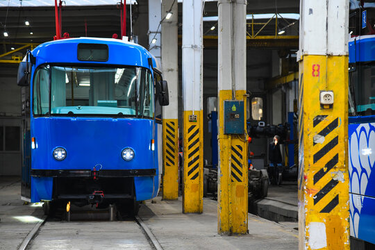 Modern tram in an industrial hall.