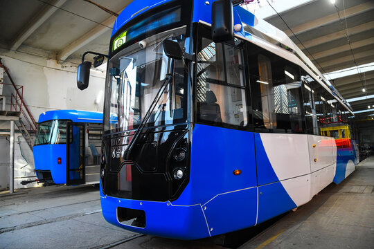 Modern tram in an industrial hall.