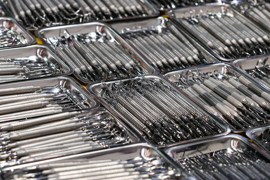 Dental instruments arranged in metal trays.