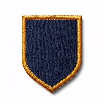 Detailed high-resolution photo of a blank shield embroidered patch with a navy blue center and gold border.