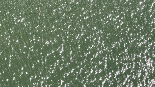 The shimmering surface of the river water. Ala Wai Canal, Honolulu, Oahu, Hawaii. The Ala Wai Canal is an artificial waterway which serves as the northern boundary of the tourist district of Waikiki. 