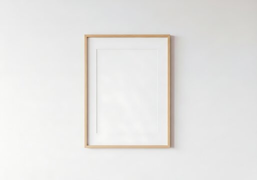Empty wooden picture frame on plain wall