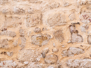 Naklejka premium Ancient stone wall showing eroded rustic texture