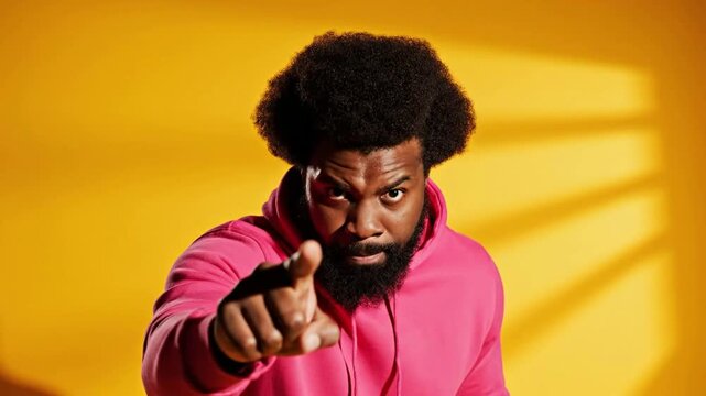 Angry African American Man Pointing Finger with Intense Expression in Pink Hoodie