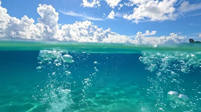 A split view of the ocean surface and blue sky above