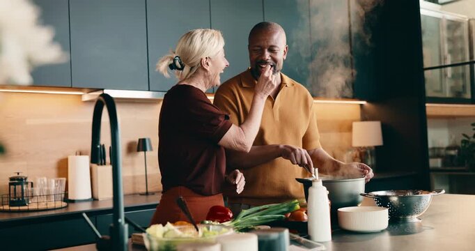 Taste, cooking and interracial couple in home with support, love and meal prep with healthy food. Mature, man and woman at stove in kitchen with recipe, help and nutrition for diet or culinary skills