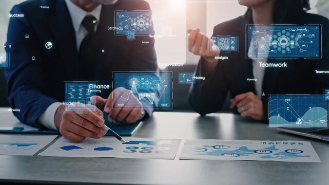 Concept of a group of business professionals holding a meeting in an office and digital technology.