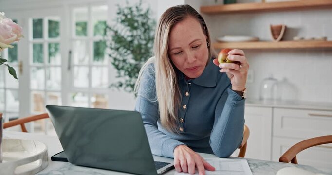 Woman, apple and remote work in house with laptop, documents and reading financial administration. Freelance, administrator and person eating fruit in home with computer, finance paperwork and review
