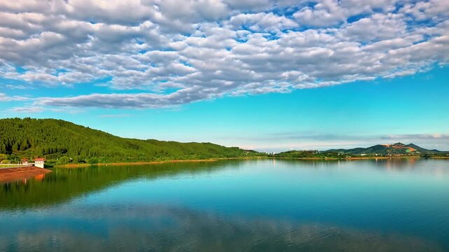 Timelapse of Huiting Reservoir - Calm Lake with Green Hills and Moving Clouds - 4K Stock Footage