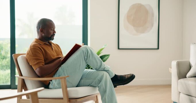 Relax, black man and reading book in home with peace, calm and literature on weekend break. Novel, study or mature person on armchair at living room with fiction story, information or knowledge hobby