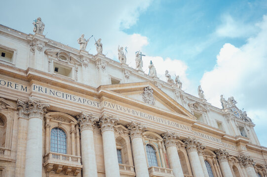 Grand facade of Saint Peters Basilica under a blue sky