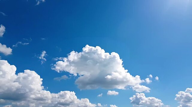 Time lapse video of white clouds moving across a bright blue sky