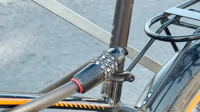 A combination cable lock secures a bicycle frame to an outdoor stand. This reliable setup offers great relief and safety. It ensures complete peace of mind.