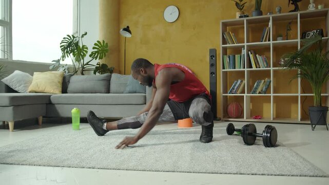 A man does a relaxing stretching routine at home for wellness