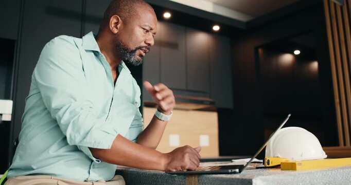 Architect, laptop and black man with documents for building plan, safety or security maintenance. Mature person, civil engineer or contractor with computer for architecture development or inspection
