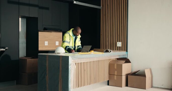 Laptop, renovation and typing with black man in kitchen for home improvement or upgrade project. Computer, real estate and writing with mature construction worker in apartment for property update