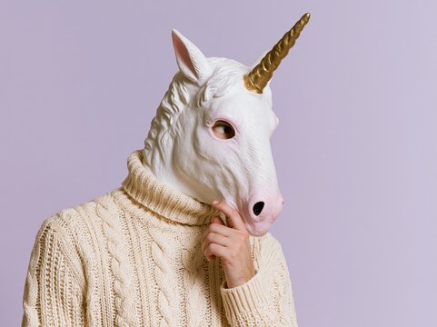 Woman wearing unicorn mask and cream cable knit sweater thinking