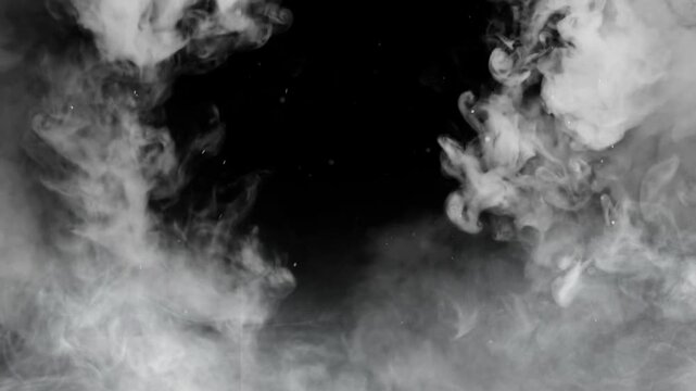 Fireworks exploding in night sky with smoke