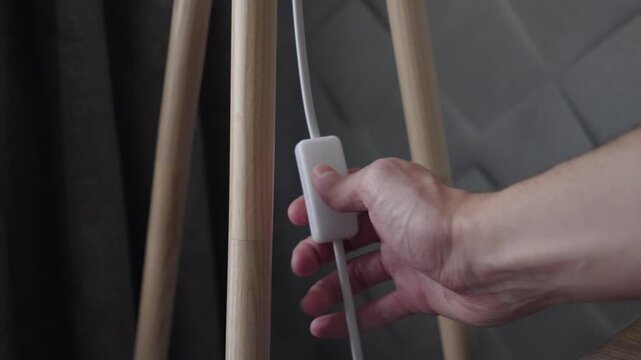 Turning On Floor Lamp Switch in Cozy Home Interior