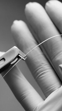Orthodontist using pliers to adjust archwire in braces treatment process