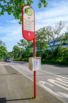 Iserlohn, Germany - June 20, 2026: Red bus stop sign for Ohl in Iserlohn, Germany, with timetable and street