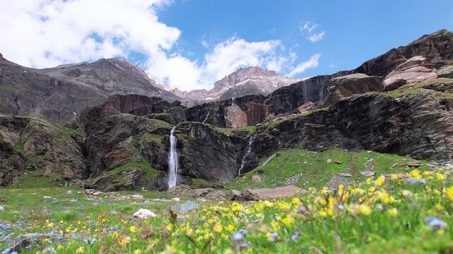 Mountains, wildflowers and waterfalls to Piani di Fora, Central Alps, Italy landscape