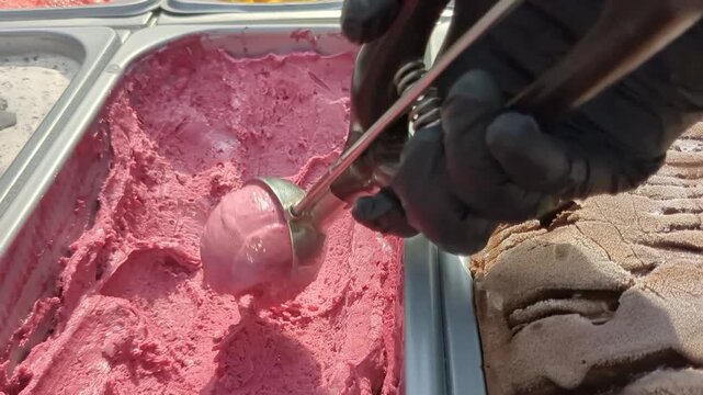 Making gelato at an outdoor shop in summer with various flavors ready for customers