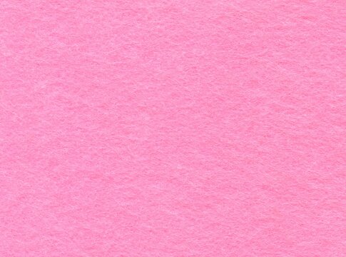 Pink, woolen, fibrous surface, background, texture. Pinky cotton covering, backdrop. Rough, a little bit fibrous pink-colored wall. Fragment of flannel, viscose or polyester surface of pink. Fleece