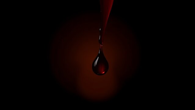 A single droplet of deep red liquid with a warm golden glow.