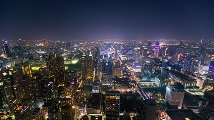 Obraz premium The Bangkok skyline at night, viewed from a rooftop bar in Thailand