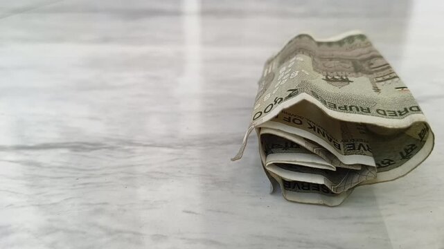 Indian rupee note falling on floor. Currency depreciation, fluctuation, devaluation, instability, decreasing value, low purchasing power, economy slowdown and market decelerate crisis concept.