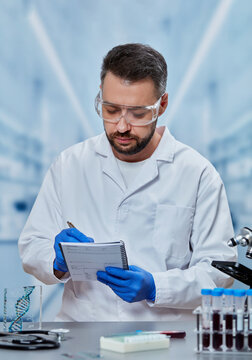 Medical laboratory scientist documenting diagnostic test results in laboratory notebook
