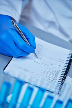 Scientist recording laboratory results, research documentation and analysis