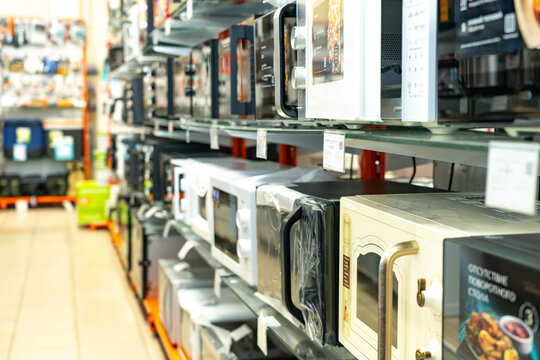 A Display of Various Microwaves Showcasing Different Designs, Sizes, and Features in a Well-Organized Retail Space for Kitchen Appliances