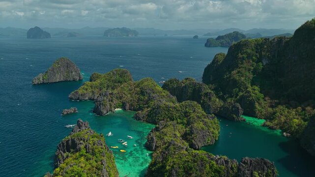 High Altitude Aerial View Flying Over Big and Small Lagoon in El Nido, Philippines. Drone Panoramic Forward Flight Showcasing Miniloc Island Limestone Ridges and Deep Blue Ocean.