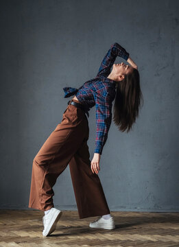 Female dancer bends backward in a powerful motion, creating a bold and expressive studio composition.