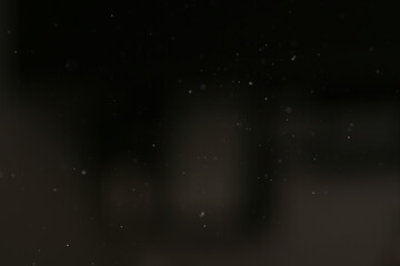 Fototapeta premium real dust particles floating in room with harsh light from light fixture