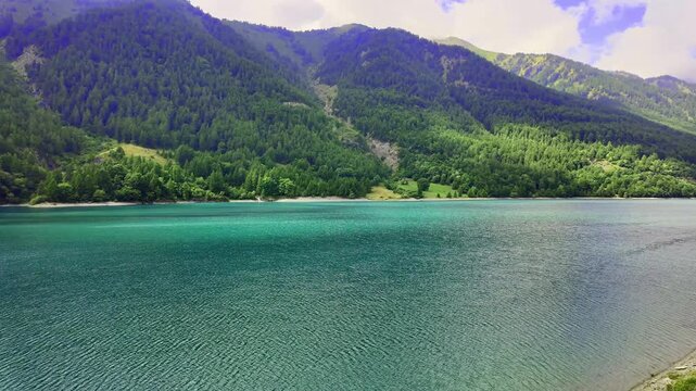 Pontechianale Lake in Piedmont: man-made dam. August holidays in the mountains