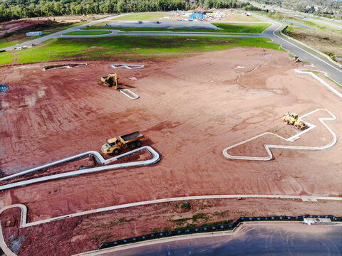 Ashburn, Virginia, United States - 17 October 2018: Aerial view of a construction site with heavy machinery including a dump truck and excavators preparing the land.
