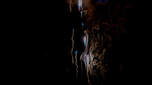 Abstract close-up footage of blue flames and swirling smoke rising from burning plastic against a deep black background. The flowing smoke creates dramatic organic patterns
