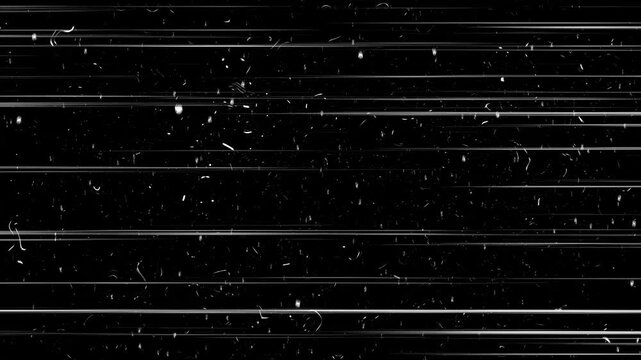 Old film grunge effect showing dust and scratches on black background. Vintage black film grain texture overlay.Vintage looping film strip background. 4K reel clutter old tv grain noise frame.