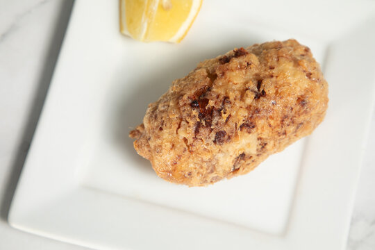 Samoussa chaud sur une assiette avec un morceau de citron &agrave; c&ocirc;t&eacute;