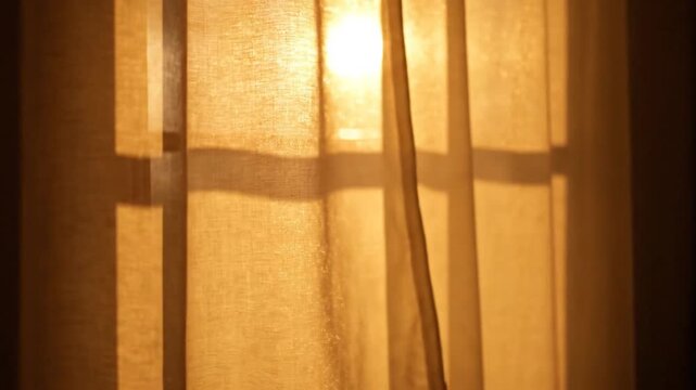 Hand opening translucent curtain to let in morning sunlight.